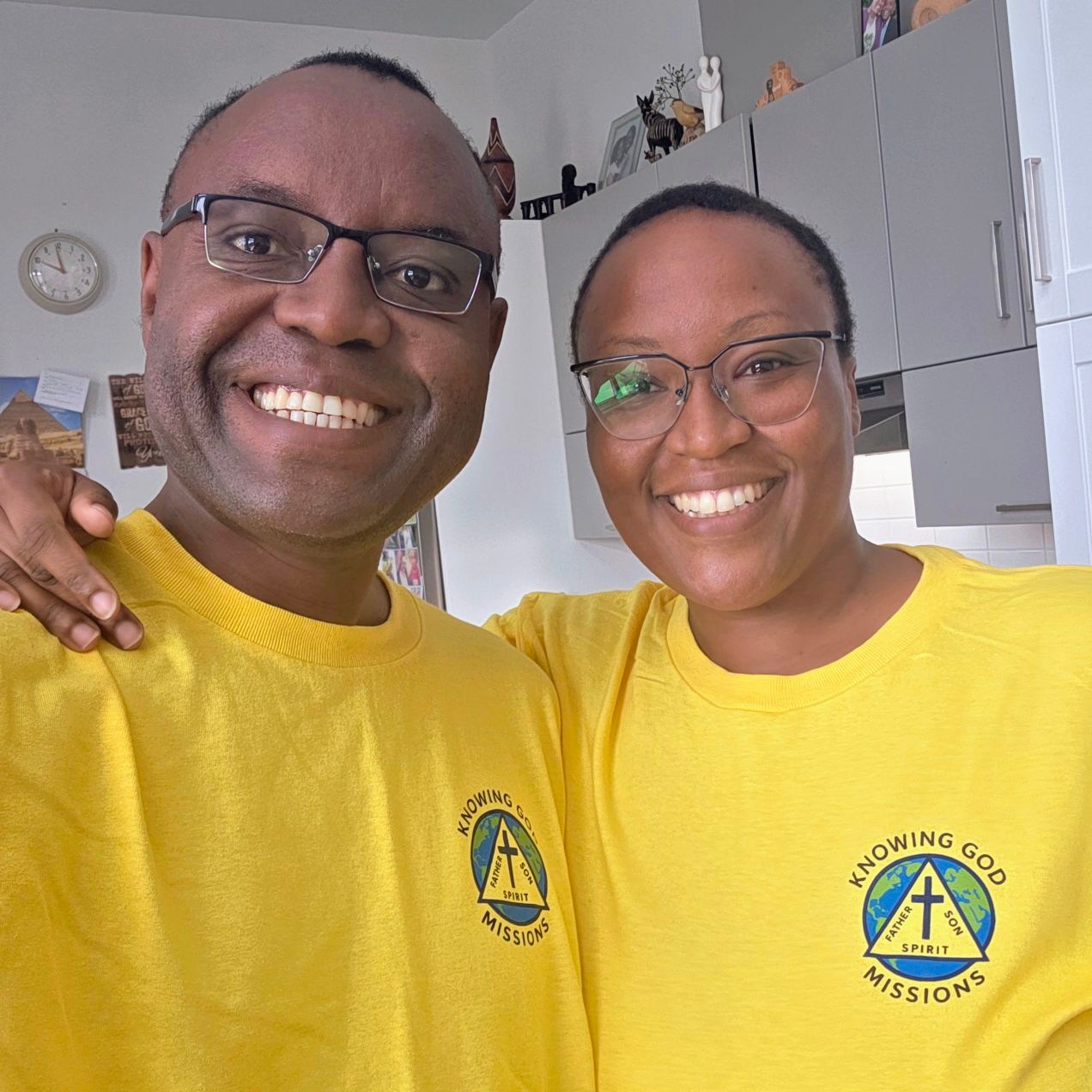Fidele and Claire Bolton wearing Knowing God Missions shirts
