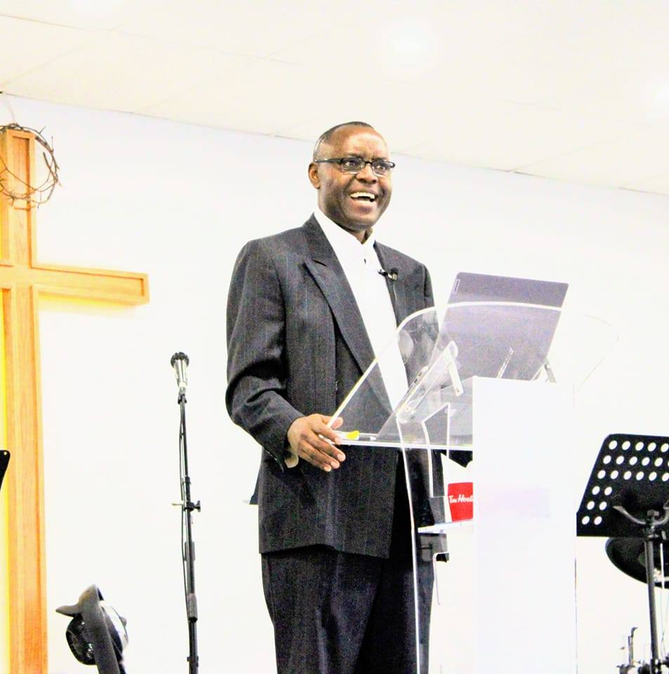 Pastor Fidele preaching at the cross